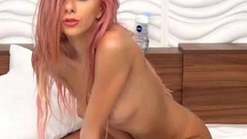 Sexy pink haired puts plays with a dildo