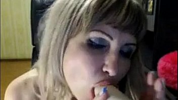 Blonde whore doing oral on a dildo