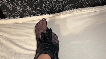 Anna wearing black gloves and fishnet stockings pleasuring herself fingering her ass and pussy