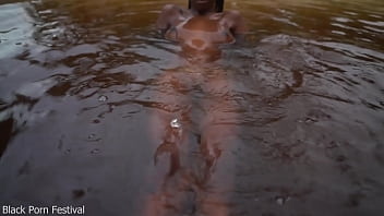 Skinny dark skinned african hottie teasing in the water
