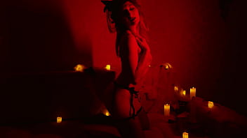 Naked beautiful witch between firing candles