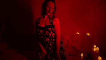 Naked beautiful witch between firing candles