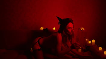 Naked beautiful witch between firing candles