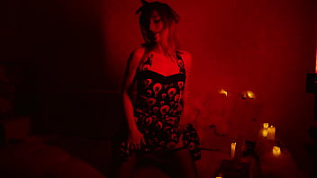 Naked beautiful witch between firing candles