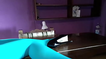 Milf with beautiful legs in pantyhose and heels lying on the table