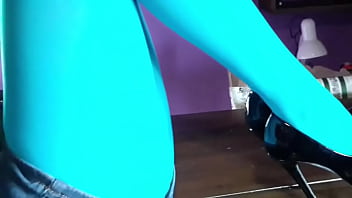 Milf with beautiful legs in pantyhose and heels lying on the table