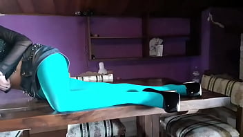 Milf with beautiful legs in pantyhose and heels lying on the table