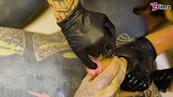 Two dominatrix fist slaves ass and finger his cock