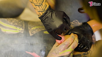 Two dominatrix fist slaves ass and finger his cock