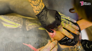 Two dominatrix fist slaves ass and finger his cock