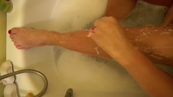 Milf shaves her legs and then rubs them with cream