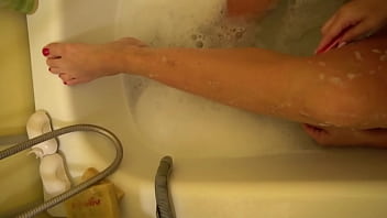 Milf shaves her legs and then rubs them with cream