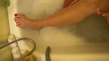 Milf shaves her legs and then rubs them with cream