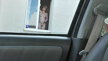 Nude woman neighbor sexy mature milf without panties and bra washes windows her apartment a taxi driver watches from car solo naked in public peeping outdoor outside publicly big natural tits pussy