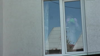 Nude woman neighbor sexy mature milf without panties and bra washes windows her apartment a taxi driver watches from car solo naked in public peeping outdoor outside publicly big natural tits pussy