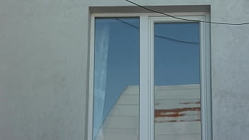 Nude woman neighbor sexy mature milf without panties and bra washes windows her apartment a taxi driver watches from car solo naked in public peeping outdoor outside publicly big natural tits pussy