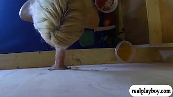 Blond babe sucks off hard cock thru gloryhole for money