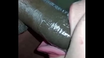 Slut swallowing a big black dick deep down her throat