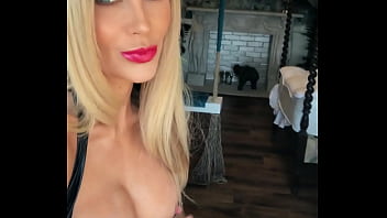 Woman in fetish gear showing off in window