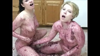 Horny lesbian babes caress themselves with food substances on the floor