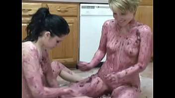 Horny lesbian babes caress themselves with food substances on the floor