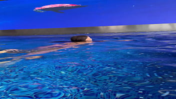 Monika fox in purple bikini swims in pool & poses by window against background of city free