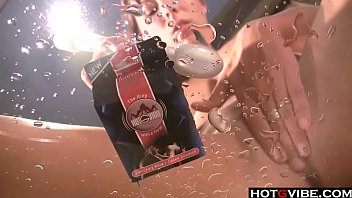 Hot brunette toys her pussy on a table