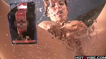 Hot brunette toys her pussy on a table