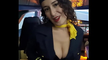 The flight attendant puts a dildo in her pussy on board