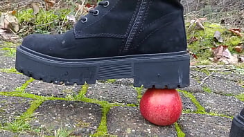 Woman crush apple underfeet