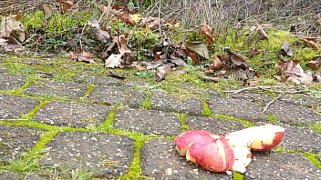 Woman crush apple underfeet