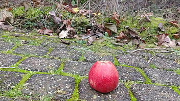 Woman crush apple underfeet