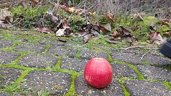 Woman crush apple underfeet