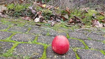 Woman crush apple underfeet