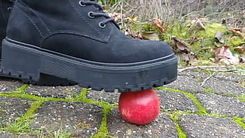Woman crush apple underfeet