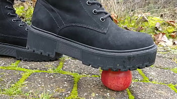 Woman crush apple underfeet