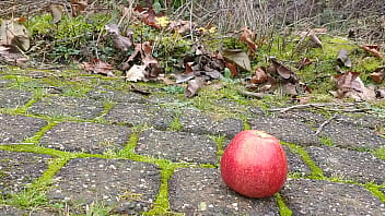 Woman crush apple underfeet