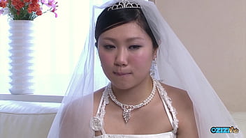 The new asian bride remains attired in her bridal gown throughout a visitor's arrival The new asian bride remains attired in her bridal gown throughout a visitor's arrival