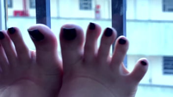 Beautiful mistress teasing with her long toes and wonderful feet