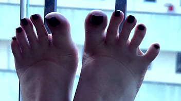 Beautiful mistress teasing with her long toes and wonderful feet