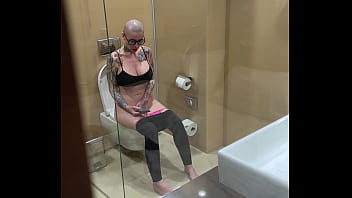 Busty girl watches porn and jerks off on the toilet peeping