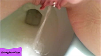 Hot bald pussy pissing in the toilet