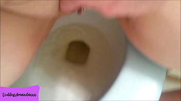 Hot bald pussy pissing in the toilet