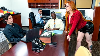 Busty redhead boss takes a thick black cock on her desk