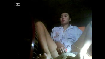 The camera under the table captured a beautiful woman at home alone and watching a porn movie