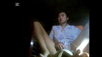 The camera under the table captured a beautiful woman at home alone and watching a porn movie