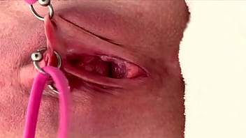 Pulling and stretching my pierced clit and pushing my pussy to pee