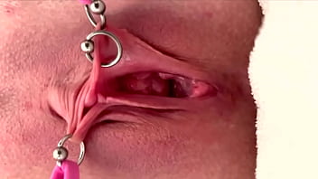 Pulling and stretching my pierced clit and pushing my pussy to pee
