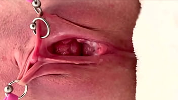 Pulling and stretching my pierced clit and pushing my pussy to pee