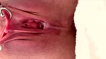Pulling and stretching my pierced clit and pushing my pussy to pee